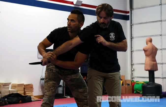 Kali master and former SWAT officer Jared Wihongi grabs Jason Jones' knife arm and can use his shoulder to control him, perform a takedown, break Jones' elbow, or transition to another position.
