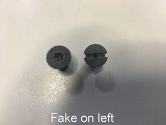 Fake uses Allen head screw with no vent hole. Real UBR uses slotted screw.
