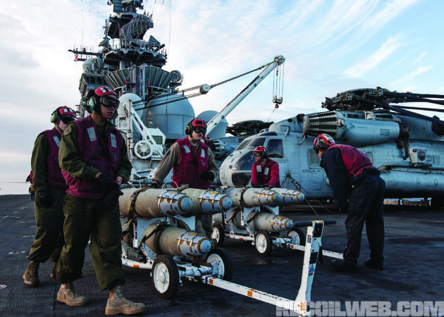 U.S. Marines load AGM-114 Hellfire missiles onto an AH-1W Super Cobra. The $117,000 “Heliborne Laser Fire and Forget Missile” was originally designed to take out tanks but were often used to take out lone ISIS snipers. Photo: U.S. Marine Corps/Ryan Young 