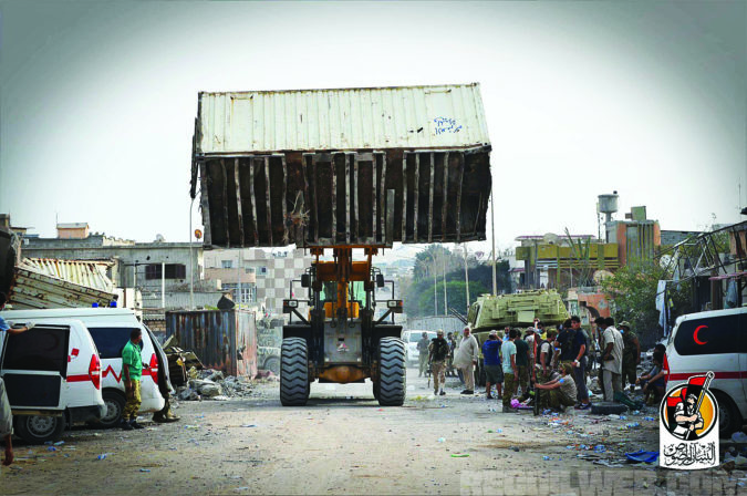 Up armored bulldozers build sand berms while forklifts build long walls of shipping containers to shield fighters from suicide vehicle attacks and snipers. Photo: courtesy Bunyan Marsous
