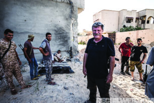 Author Robert Young Pelton, relaxing with al Bunyan Marsous militia fighters in between clearing buildings in District 3. The sea front area was the last ISIS hold out in Sirte.