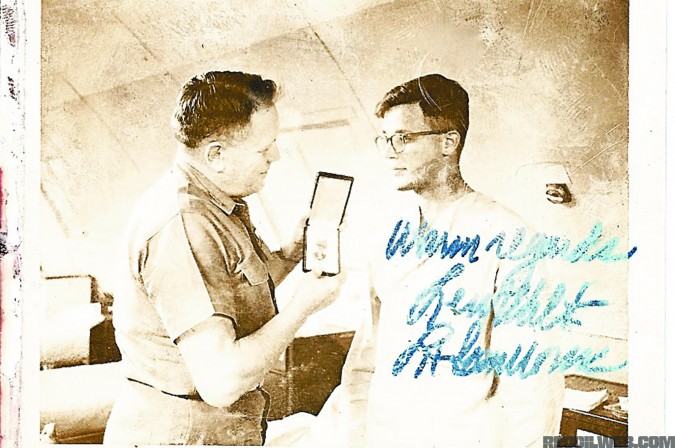 Smith is presented with the Purple Heart from USMC General Lew Walt. While he was presented the medal, the paperwork wouldn't catch up to Smith for decades.
