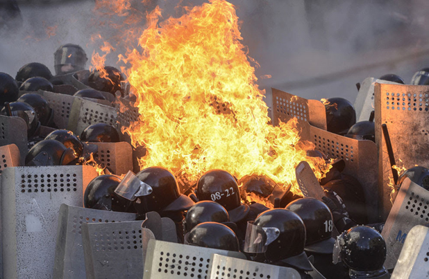 Reuters image by Andrew Kravenchko Ukrainian riot police on fire