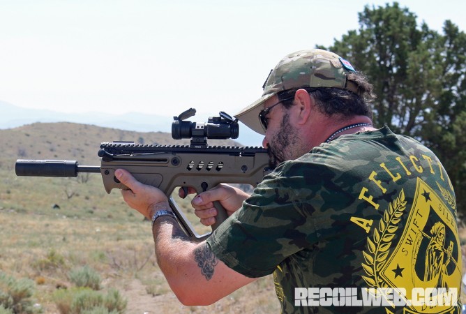 Author firing Tavor with Suppressed Armament silencer