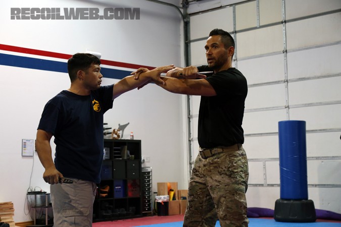 Kali master and former SWAT officer Jared Wihongi performs a knife flow drill with his senior instructor Lamont Glass.