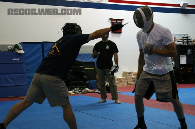 Kali instructor Lamont Glass, left, "jabs" at his opponents eyes with a training knife during a sparring session.