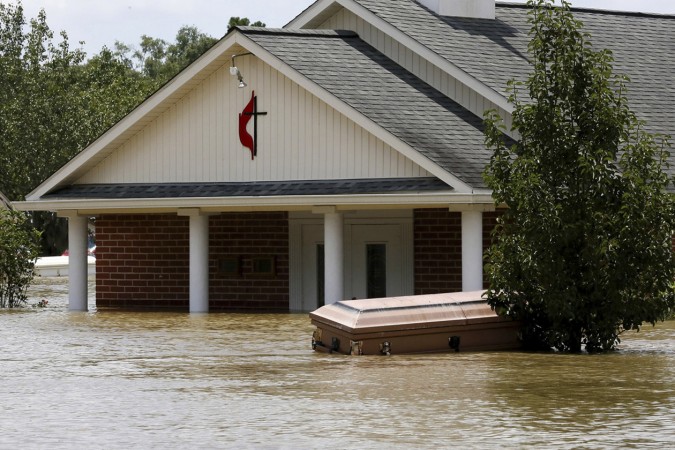 A casket is seen in front of a partially submerged church in Ascension Parish, Louisiana, U.S., August 15, 2016.  REUTERS/Jonathan Bachman   - RTX2L1QH
