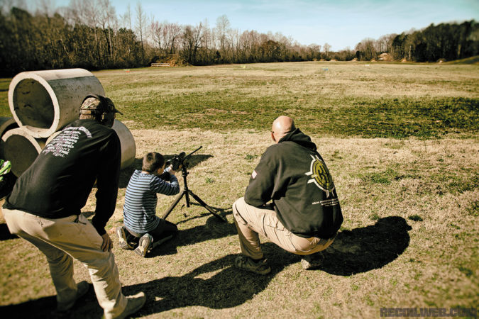K&M Owner, Shannon Kay (bottom right), watches as his youngest son takes to the 100-yard target. 