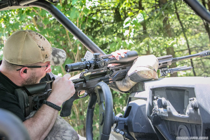 Jack Cullotta works his CADEX rifle from the cockpit of a side-by-side during the first day of the PRS New England match.
