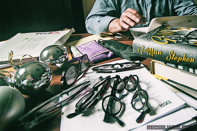 Baltimore, Md, 6/23/17--- Author Stephen Hunter says that he orders reading glasses in bulk, because he constantly misplaces them. On left are decorations from a Super Bowl party for the Baltimore Ravens held several years ago.. /// photograph by Jed Kirschbaum--digital image_EJK1757