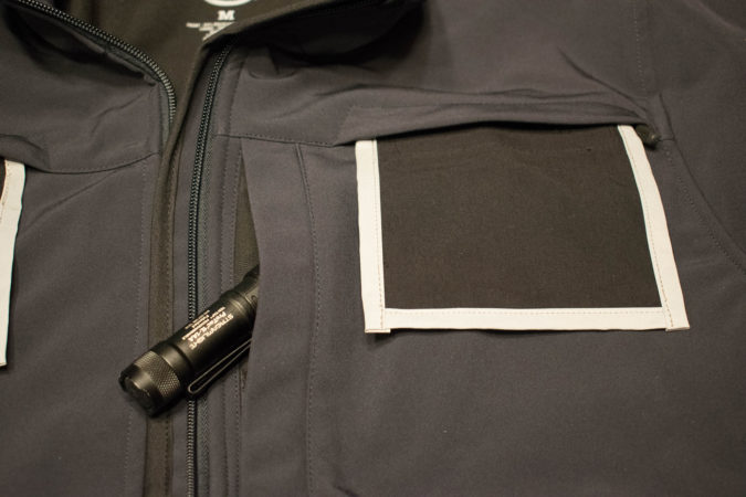 Jacket hidden chest pocket and reflective panels