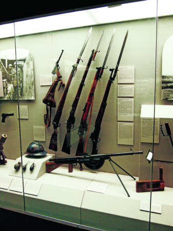 1. A collection of World War I small arms, including bolt-action rifles from the combatant nations above a French Chauchat light machine gun — the first such weapon that could be truly carried by a single soldier. The weapon earned a terrible reputation, but despite this fact it influenced later firearm designs. 