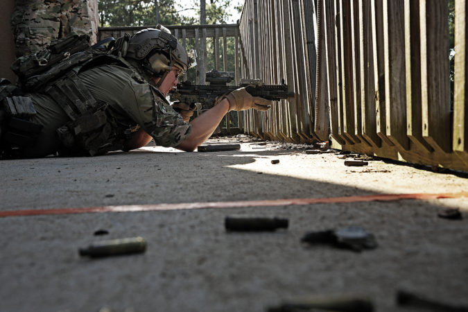 An operator engages targets several hundred yards out with his red-dot–equipped 10.5-inch Mk18. Shooters were required to utilize multiple unconventional positions throughout this stage.
