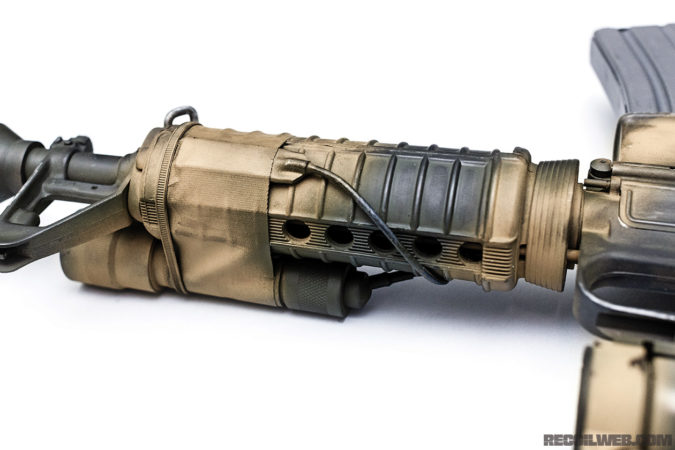 The Gordon CAR-15 prop rifle 8-hole handguard. The ETAC Arms live-fire replica is equipped with an 8-hole carbine handguard constructed from an M16A2 full length handguard and a Surefire tactical light. The duct tape and zip tie matches the configuration shown in the film. 