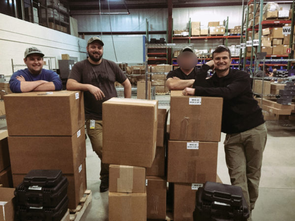 The Defense Strategies Group boxing up MHS pistols for the original submission in 2016. Photo courtesy of SIG SAUER