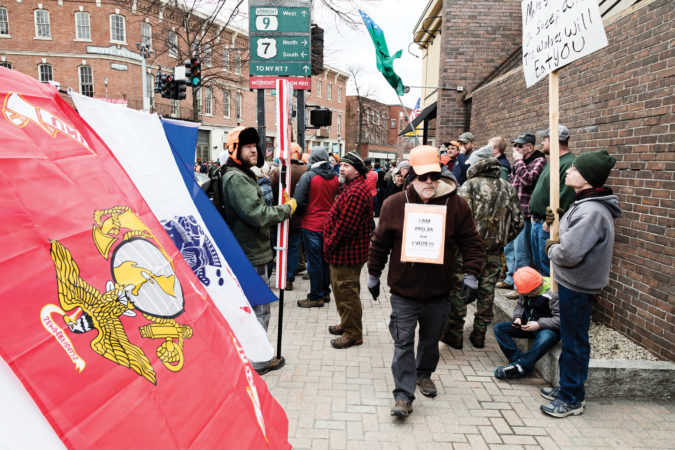 A crowd of gun rights supporters filled the Four Corners downtown of Bennington, to protest the Legislature's passage of S.55, legislation that puts new limits on gun ownership in Vermont. vermont gun owners group gun rights group scam