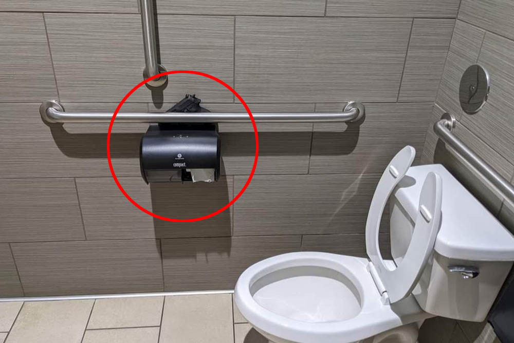 Lost pistol on a toiletpaper dispenser.