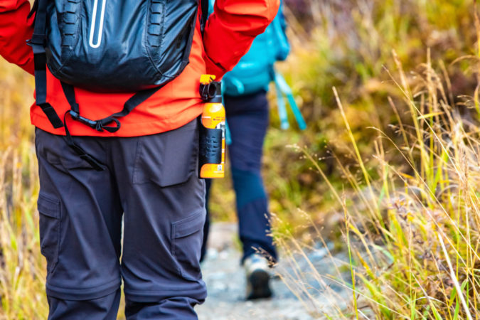 Bear spray self-defence attached to backpackers when hiking in national park